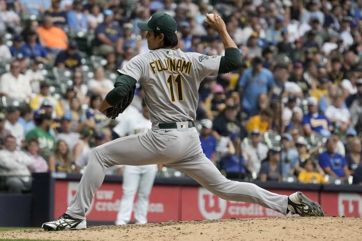 Shintaro Fujinami of the Oakland Athletics pitches against the Milwaukee  Brewers in a spring training game