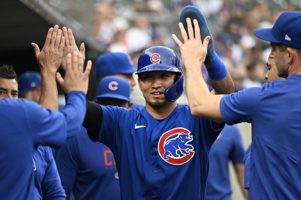 Chicago Cubs' Seiya Suzuki scores in the first inning during a