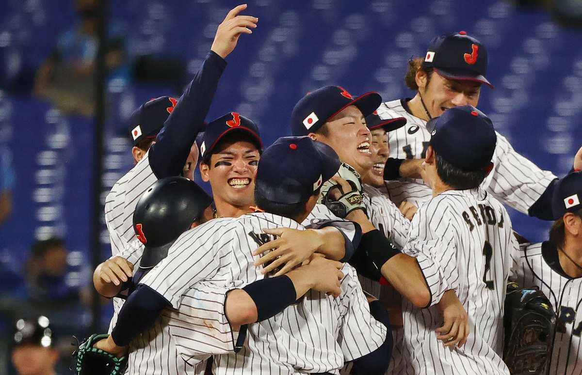 Japan national baseball team members celebrate after beating China