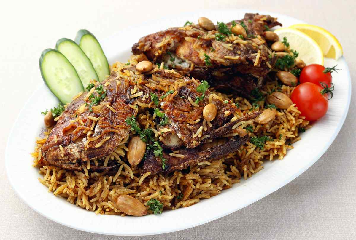 Japanese Expert on Arab Cuisine Presents Dish with Whole Fish, Creating a Decorative Delicacy